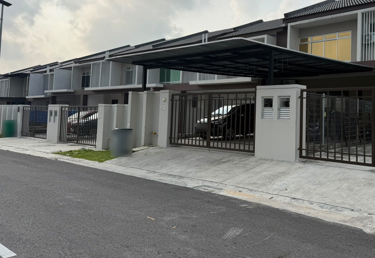 Cantilevered metal awning over the car porch of a terrace house